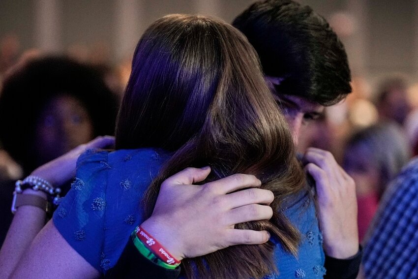 An Apalachee High School student is embraced during a Sunday service at Bethlehem Church, Sunday, Sept. 8, 2024, in Bethlehem, Ga. Colt Gray, 14, has been charged with murder over the killing of two students and two teachers at Apalachee High School in Barrow County, outside Atlanta, on Wednesday. (AP Photo/Mike Stewart)