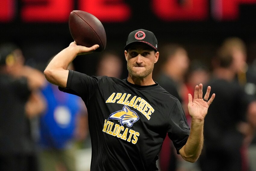 Atlanta Falcons quarterback Kirk Cousins warms up while wearing an Apalachee High School T-shirt before a game against the Pittsburgh Steelers on Sunday, Sept. 8, 2024, in Atlanta. (AP Photo/John Bazemore)