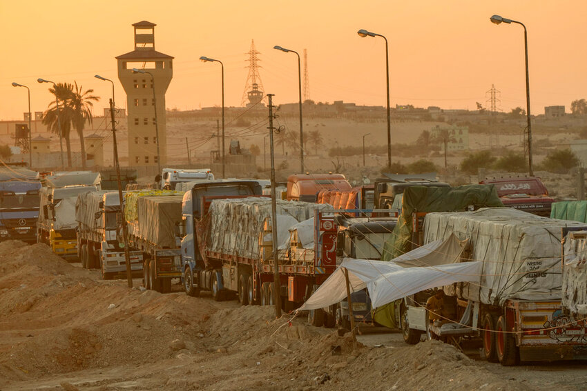 Trucks of humanitarian aids wait to cross the Rafah border crossing between Egypt and the Gaza Strip, in Rafah, Egypt, Monday, Sept. 9, 2024. (AP Photo)