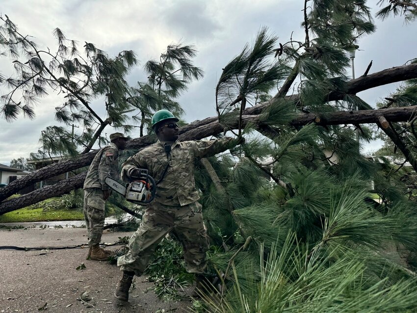 A National Guardsman removes a fallen tree from a road in Morgan City, La. on Thursday, Sept. 12, 2024, after Hurricane Francine passed through. (AP Photo/Jack Brook)