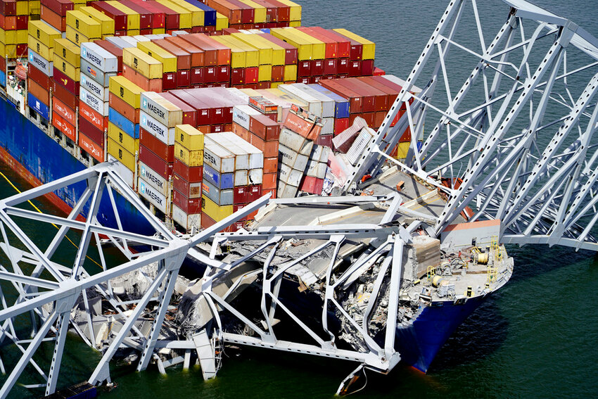 The cargo ship Dali is stuck under part of the structure of the Francis Scott Key Bridge after the ship hit the bridge, March 26, 2024, in Baltimore. (Maryland National Guard via AP, File)