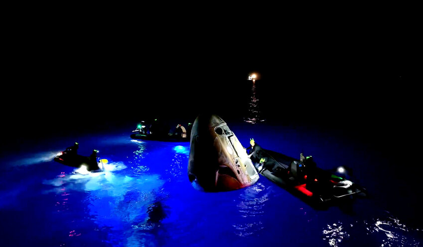 This image made from SpaceX video shows its capsule, center, carrying tech entrepreneur Jared Isaacman with his crew after it reached the Gulf of Mexico near Florida's Dry Tortugas early Sunday, Sept. 15, 2024. (SpaceX via AP)