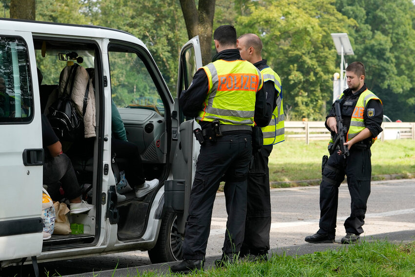 German police check the details of a van from Bulgaria near the border to Belgium in Aachen, Germany, Monday, Sept. 16, 2024, as Germany begins carrying out checks at all its land borders. (AP Photo/Martin Meissner)