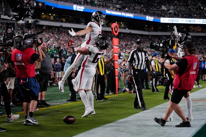 Atlanta Falcons wide receiver Drake London (5) celebrates his touchdown with guard Chris Lindstrom (63) during the second half against the Philadelphia Eagles on Monday, Sept. 16, 2024, in Philadelphia. (AP Photo/Matt Rourke)