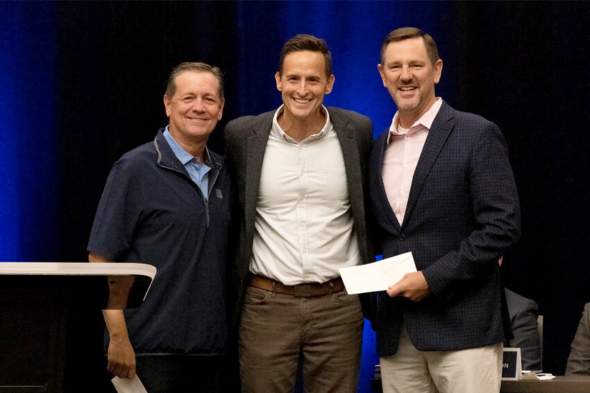 Ben Mandrell, center, president and CEO of Lifeway Christian Resources, presented checks totaling $678,283.32 to International Mission Board president Paul Chitwood, right, and North American Mission Board president Kevin Ezell on Tuesday, Sept. 17, during the Southern Baptist Convention Executive Committee trustee meeting. (SBC/Brandon Porter)