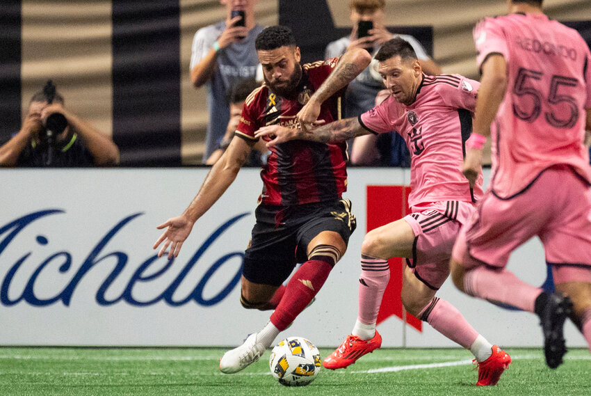 Inter Miami forward Lionel Messi, right, and Atlanta United defender Derrick Williams battle for control of the ball during the second half Wednesday, Sept. 18, 2024. (AP Photo/John Bazemore)