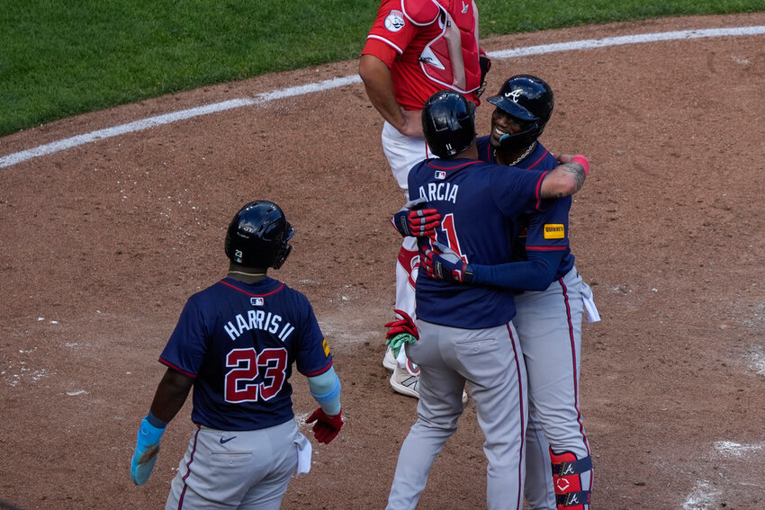 Atlanta Braves' Jorge Soler, right, embraces teammate Orlando Arcia, center, after hitting a 3-run home run during the sixth inning against the Cincinnati Reds, Thursday, Sept. 19, 2024, in Cincinnati. (AP Photo/Joshua A. Bickel)