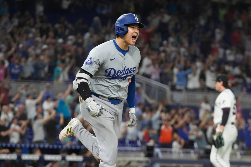 Los Angeles Dodgers' Shohei Ohtani (17) reacts after hitting his 50th home run of the season during the seventh inning against the Miami Marlins, Thursday, Sept. 19, 2024, in Miami. (AP Photo/Marta Lavandier)