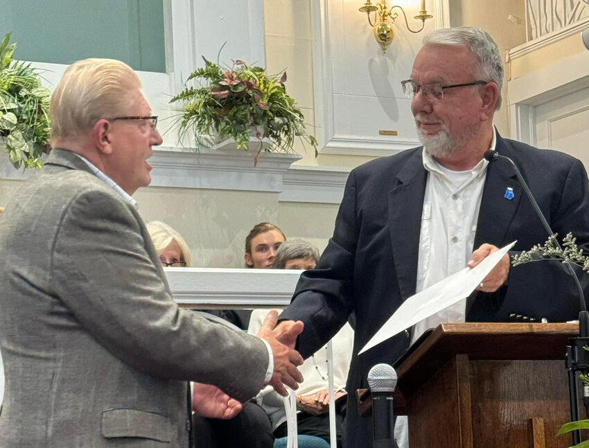 Ricky Thrasher presents Frank Nuckolls, left, with a letter of appreciation at the 200th anniversary celebration of the Flint River Baptist Association.