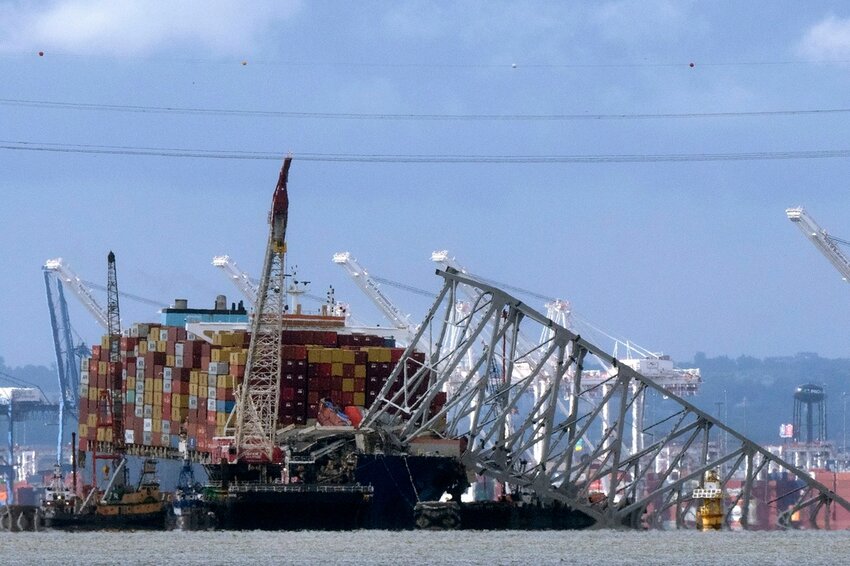 FILE - The collapsed Francis Scott Key Bridge rests on the container ship Dali, May 12, 2024, in Baltimore, as seen from Riviera Beach, Md.   (AP Photo/Mark Schiefelbein, File)