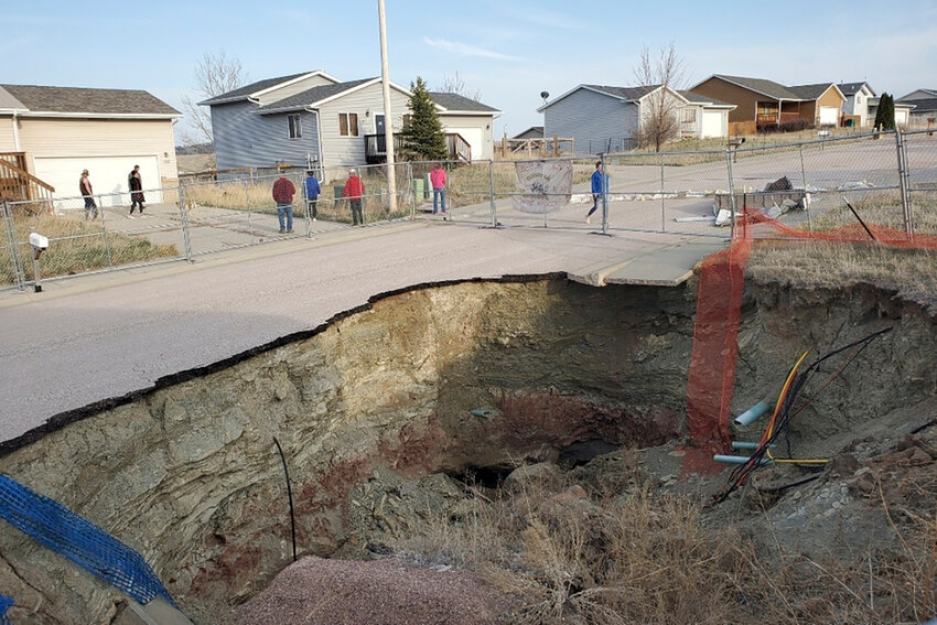 This photo taken April 27, 2022, by Tonya Junker shows a sinkhole in the Hideaway Hills neighborhood near Rapid City, S.D. (Tonya Junker via AP)