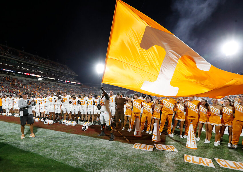 Tennessee offensive lineman Javontez Spraggins (76) waves a giant Tennessee flag after his team defeated Oklahoma, Saturday, Sept. 21, 2024, in Norman, Okla. (AP Photo/Alonzo Adams)