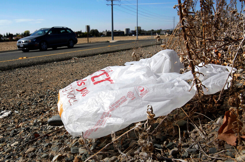 A plastic bag sits along a roadside in Sacramento, Calif., Oct. 25, 2013. (AP Photo/Rich Pedroncelli, File)