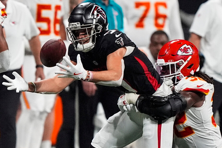 Atlanta Falcons wide receiver Drake London (5) loses the ball but recovers against Kansas City Chiefs linebacker Nick Bolton (32) during the second half Sunday, Sept. 22, 2024, in Atlanta. (AP Photo/Brynn Anderson)