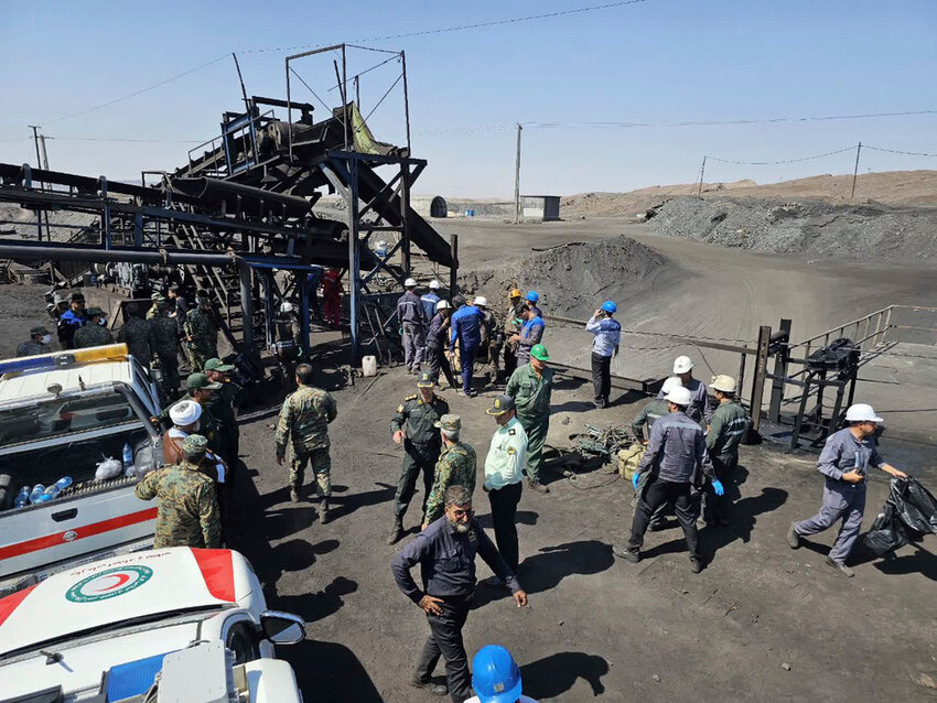 Miners and police officers are seen at the site of a coal mine where a methane leak sparked an explosion on Saturday, in Tabas, Iran, Sunday, Sept. 22, 2024. (Iranian Red Crescent Society, via AP)