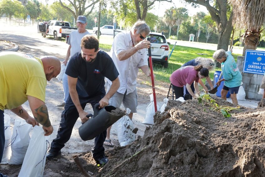 Residents fill sandbags to prepare their homes for potential flooding Tuesday, Sept. 24, 2024, in Tarpon Springs, Fla., as Tropical Storm Helene approaches. (Douglas R. Clifford/Tampa Bay Times via AP)