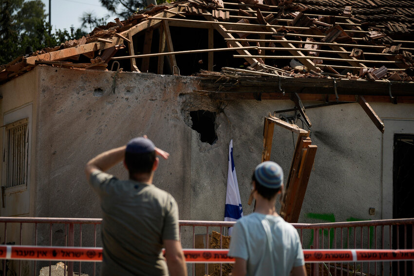 People look at a damaged house that was hit by a rocket fired from Lebanon, near Safed, northern Israel, on Wednesday, Sept. 25, 2024. (AP Photo//Leo Correa)