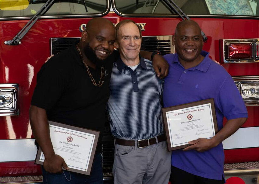 G.T. Myers stands between James Good, right, and Victor Player, the two hotel employees who helped to save Myers; life. (Photo/Courtesy G.T. Myers)