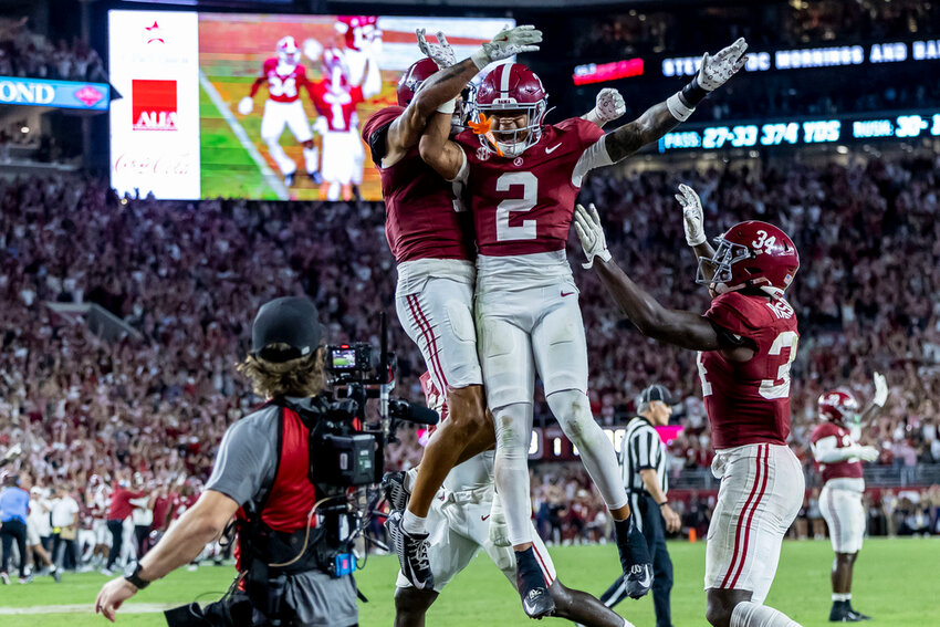 Alabama defensive back Domani Jackson, left, celebrates with defensive back Zabien Brown (2) and linebacker Que Robinson (34) after Brown intercepted a pass in the final minute during the second half of an NCAA college football game against Georgia, Saturday, Sept. 28, 2024, in Tuscaloosa, Ala. (AP Photo/Vasha Hunt)