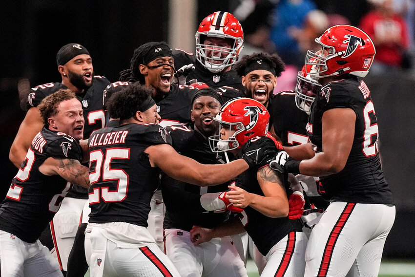 Atlanta Falcons players celebrate place kicker Younghoe Koo's game-winning 58-yard-field goal against the New Orleans Saints during the second half Sunday, Sept. 29, 2024, in Atlanta. (AP Photo/John Bazemore)