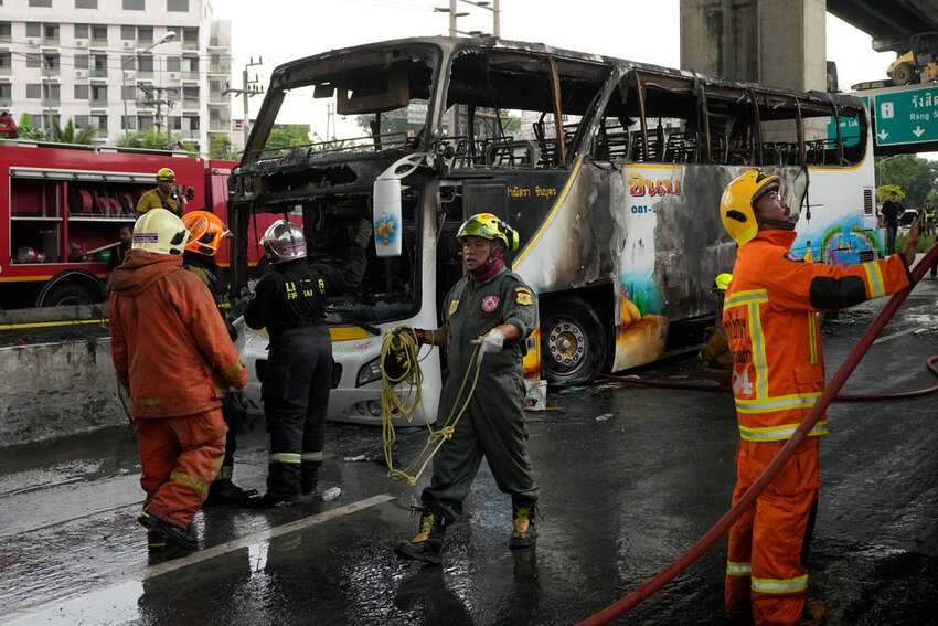 Rescuers work at the site of school bus that caught fire in suburban Bangkok, Tuesday, Oct. 1, 2024. (AP Photo/Sakchai Lalit)