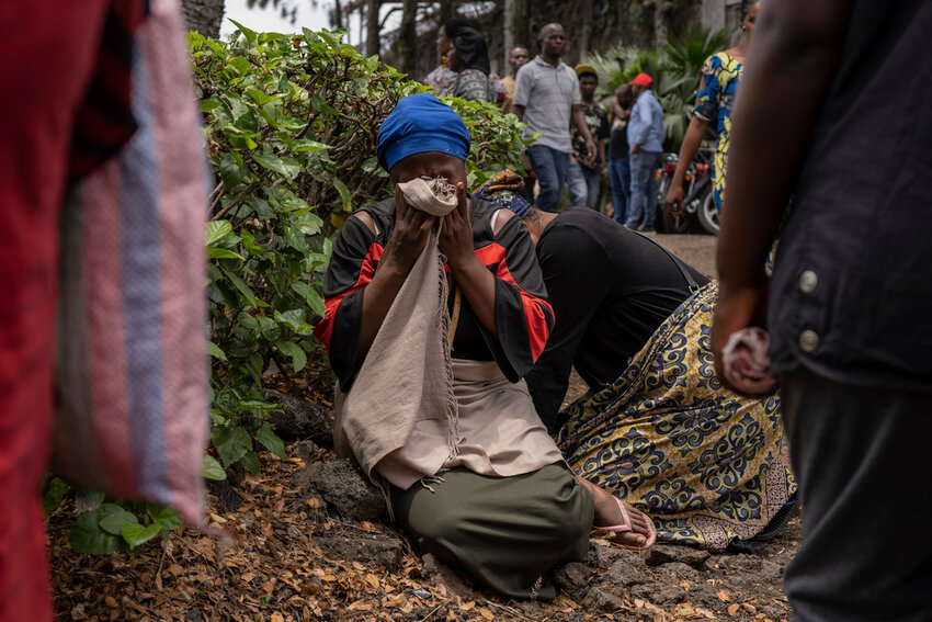 Women grieve at the port of Goma, Democratic Republic of Congo, after a ferry carrying hundreds capsized on arrival Thursday, Oct. 3, 2024. (AP Photo/Moses Sawasawa)