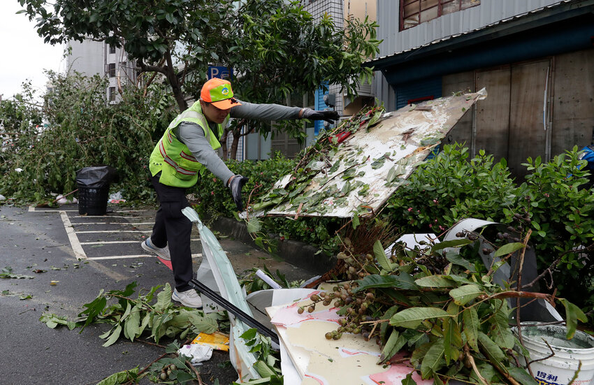 A sanitation worker of Kaohsiung city government clears debris in the aftermath of Typhoon Krathon in Kaohsiung, southern Taiwan, Friday, Oct. 4, 2024. (AP Photo/Chiang Ying-ying)