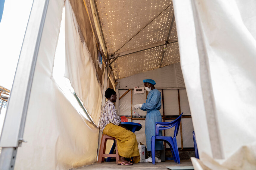 FILE - A health worker attends to a mpox patient, at a treatment centre in Munigi, eastern Congo, Monday, Aug. 19, 2024.   (AP Photo/Moses Sawasawa, File)