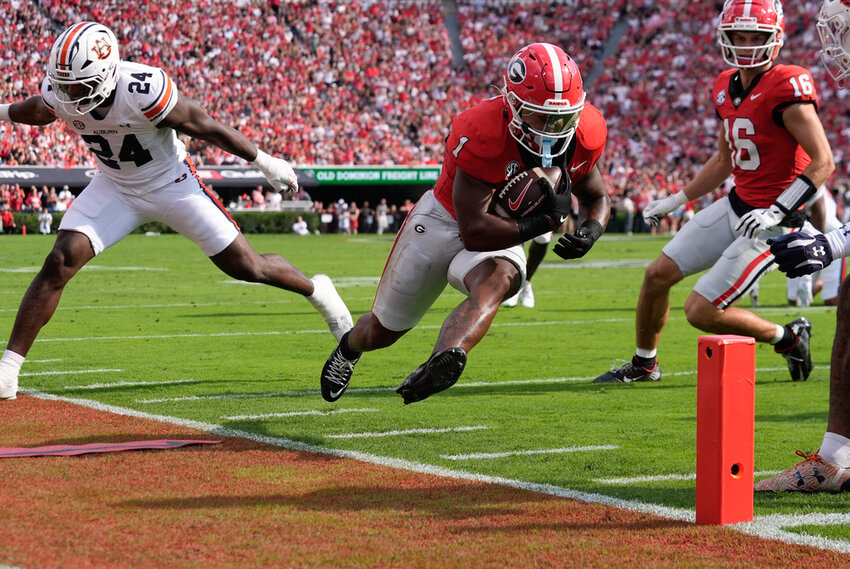 Georgia running back Trevor Etienne (1) is forced out of bounds by Auburn's Keyron Crawford (24) short of the end zone after making a catch in the first half Saturday, Oct. 5, 2024, in Athens, Ga. (AP Photo/John Bazemore)