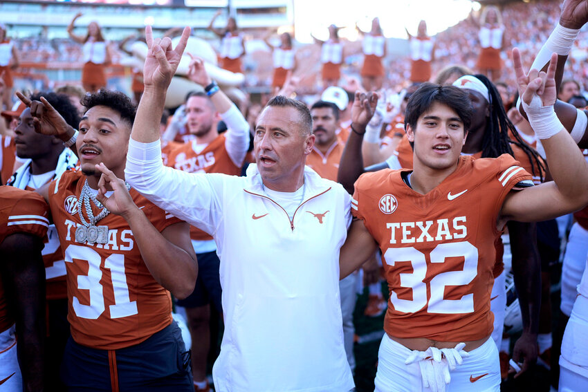 Texas head coach Steve Sarkisian, center, joins players for the school song following their win over Mississippi State in Austin, Texas, Saturday, Sept. 28, 2024. (AP Photo/Eric Gay)