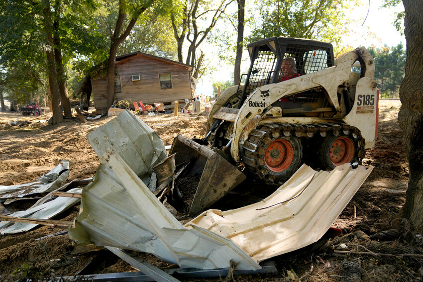 Debris left in the aftermath of Hurricane Helene is cleared Saturday, Oct. 5, 2024, in Del Rio, Tenn. (AP Photo/Jeff Roberson)