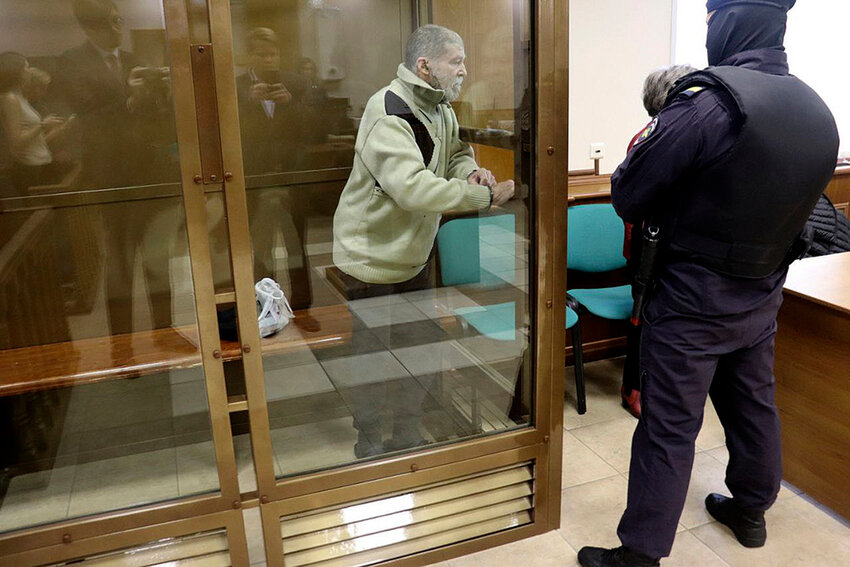 Stephen Hubbard, a U.S. citizen accused of fighting as a mercenary in Ukraine against Russia stands in a glass cage during a court session in the Moscow City court Monday, Oct. 7, 2024. (Moscow City Court Press Service via AP)