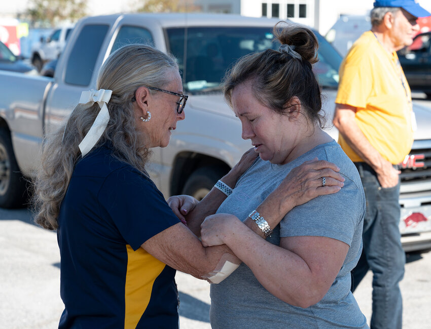 A Georgia Baptist Disaster Relief chaplain prays for a woman in Alma, Ga. (Index/Henry Durand)