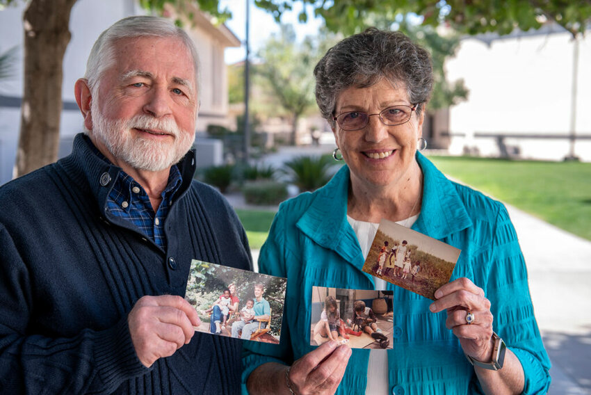 Larry and Sharon Pumpelly, who served for 26 years as missionaries, show photos from their years in Africa. (Photo/IMB)