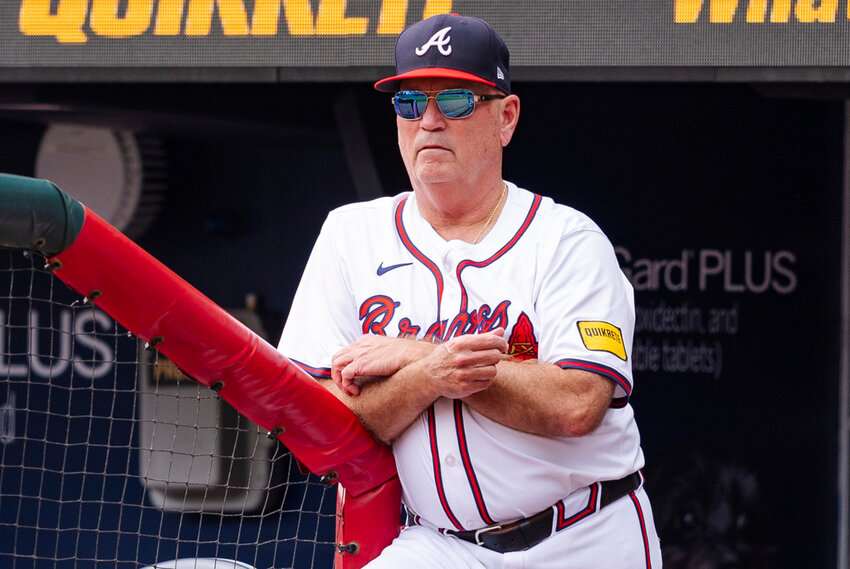 Atlanta Braves manager Brian Snitker watches from the dugout in the third inning of a baseball game against the New York Mets, Monday, Sept. 30, 2024, in Atlanta. (AP Photo/Jason Allen, File)