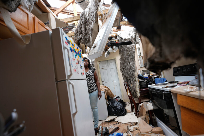 Natasha Ducre surveys the kitchen of her devastated home, which lost most of its roof during the passage of Hurricane Milton, in Palmetto, Fla., Thursday, Oct. 10, 2024. (AP Photo/Rebecca Blackwell)