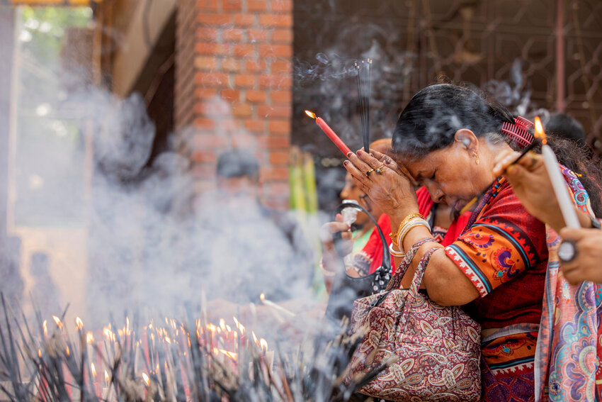 A woman offers prayer at the Dhakeshwari National Temple during the Durgapuja festival in Dhaka, Bangladesh, on Oct. 10, 2024. (AP Photo/Rajib Dhar)