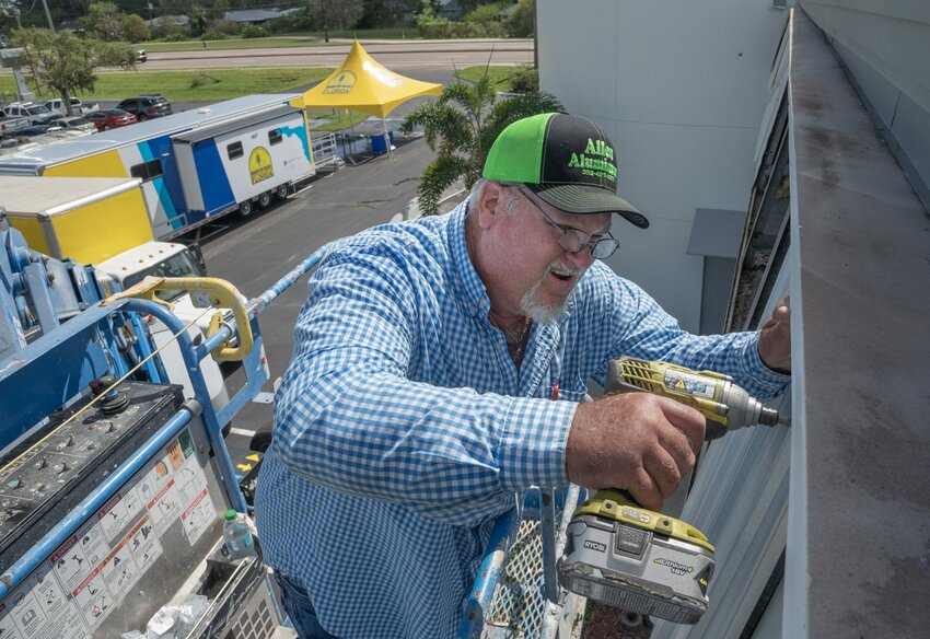 Working high over the parking lot of Sarasota’s Colonial Oaks Baptist Church, volunteer David Allen, from Concord Baptist Church, Chiefland, repairs the church’s hurricane-damaged roof. Colonial Oaks has opened its doors to serve as the Florida Baptist Disaster Relief command center to coordinate Hurricane Milton recovery efforts. Florida Baptist Witness photo.