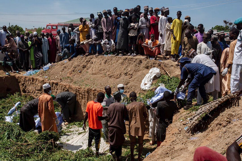 People prepare bodies for funeral following a tanker explosion in Majiya town, Nigeria, Wednesday, Oct.16, 2024. ( AP Photo/ Sani Maikatanga)