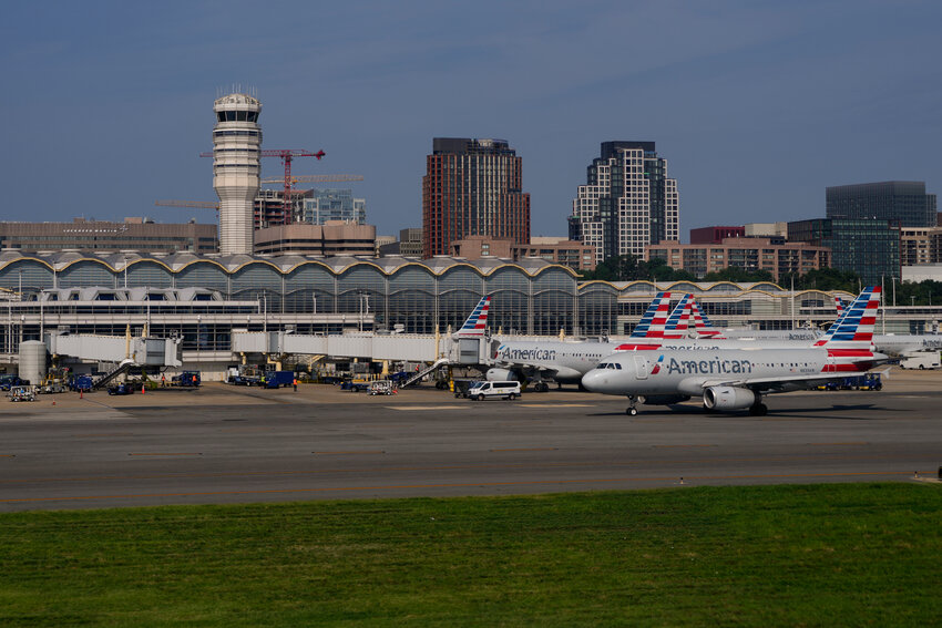 FILE - Planes are parked at gates are at Ronald Reagan Washington National Airport in Arlington, Va., Sunday, Aug. 27, 2023, in Washington. (AP Photo/Carolyn Kaster, File)