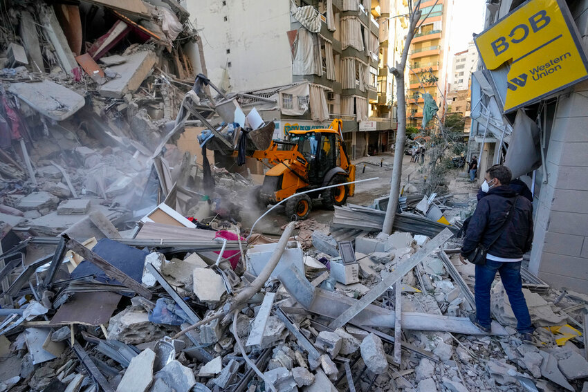 Rescue workers use a bulldozer to remove rubble of destroyed buildings at the site of an Israeli airstrike on Sunday night that hit several branches of the Hezbollah-run al-Qard al-Hassan in Beirut's southern suburb, Lebanon, Monday, Oct. 21, 2024. (AP Photo)