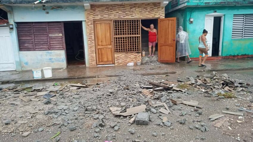 A Cuban woman stands at the door of her home, surveying the devastation left behind by Hurricane Oscar. (Photo/Florida Baptist Convention)