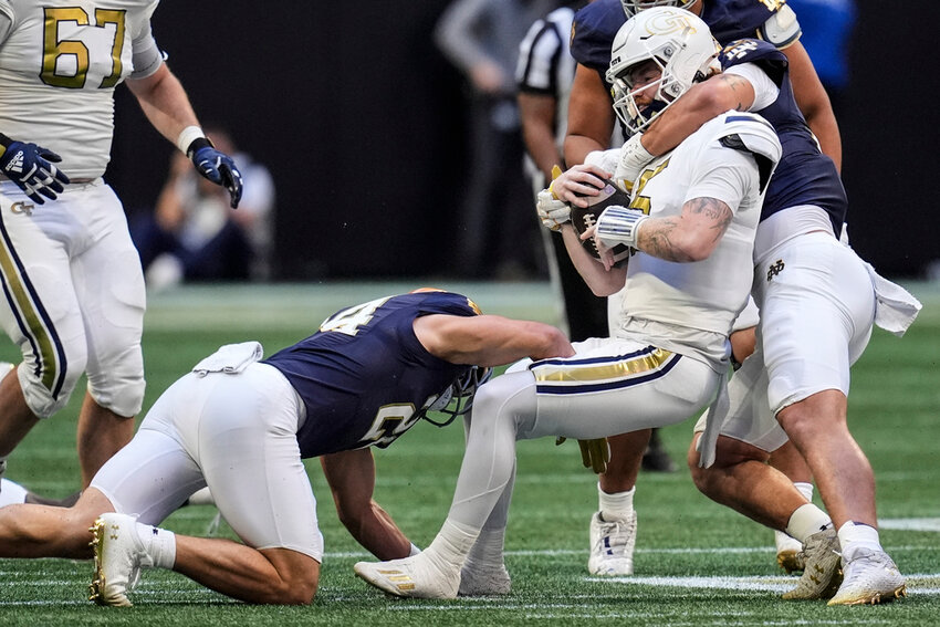 Georgia Tech quarterback Zach Pyron is hit by Notre Dame defenders during the first half Saturday, Oct. 19, 2024, in Atlanta. (AP Photo/Mike Stewart)