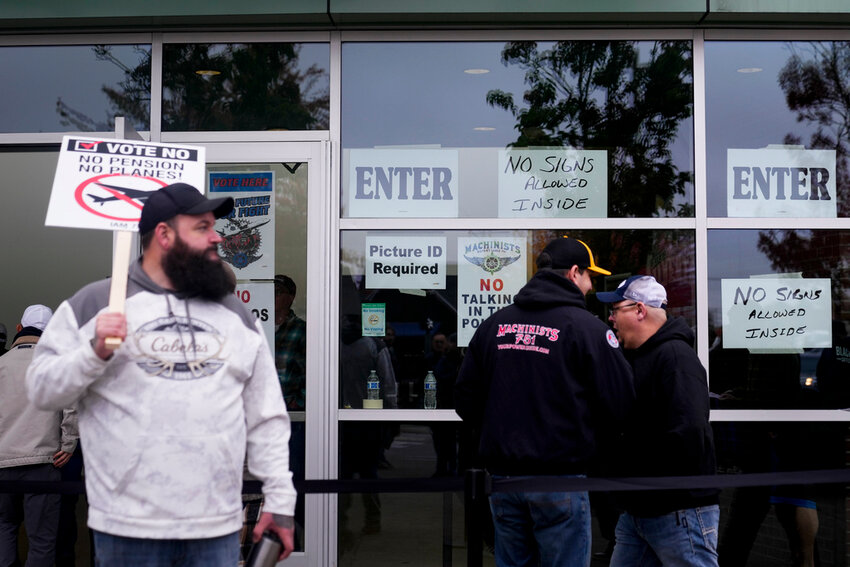 Boeing employees on strike enter a voting location to cast their ballots on a new contract offer from the company Wednesday, Oct. 23, 2024, in Everett, Wash. (AP Photo/Lindsey Wasson)