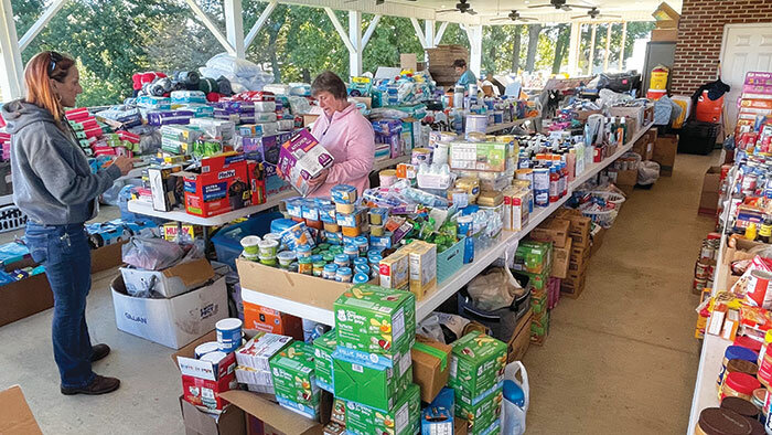 Volunteers at New Salem Baptist Church in Limestone, Tenn., prepare for distribution of a wide variety of donations the church has received and that will go out to the surrounding area where flooding from the Nolichucky River caused extensive damage. (Baptist and Reflector/Chris Turner)