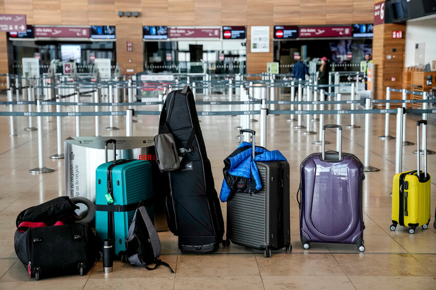 Passengers' luggage sits on the floor at the Berlin-Brandenburg airport, during the airports warning strike, Monday, March 10, 2025. (AP Photo/Ebrahim Noroozi)