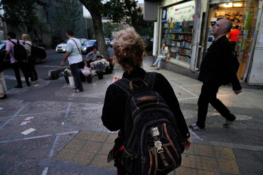 An Iranian woman, without a mandatory headscarf, or hijab, walks in downtown Tehran, Iran, June 10, 2024. (AP Photo, File)