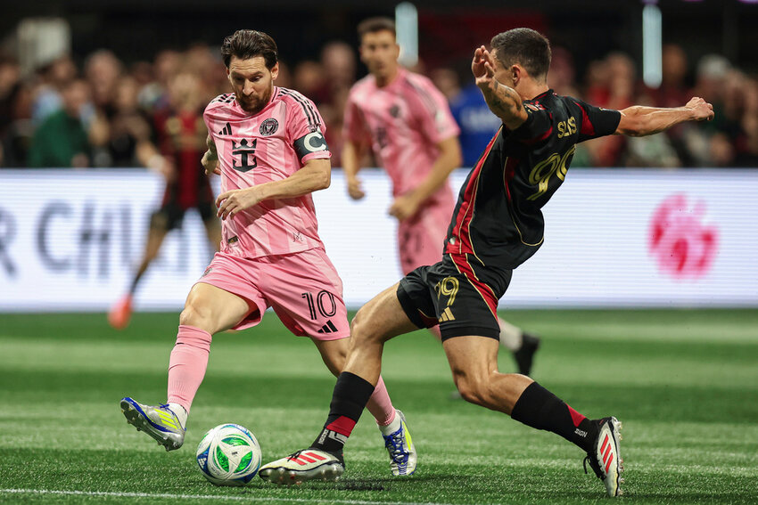 Inter Miami forward Lionel Messi (10) fights for the ball against Atlanta United midfielder Bartosz Slisz, right, during the first half Sunday, March, 16, 2025, in Atlanta. (AP Photo/Colin Hubbard)