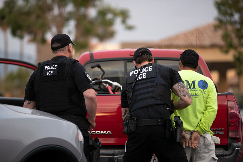 U.S. Immigration and Customs Enforcement officers detain a man during an operation in Escondido, Calif., July 8, 2019. (AP Photo/Gregory Bull, File)