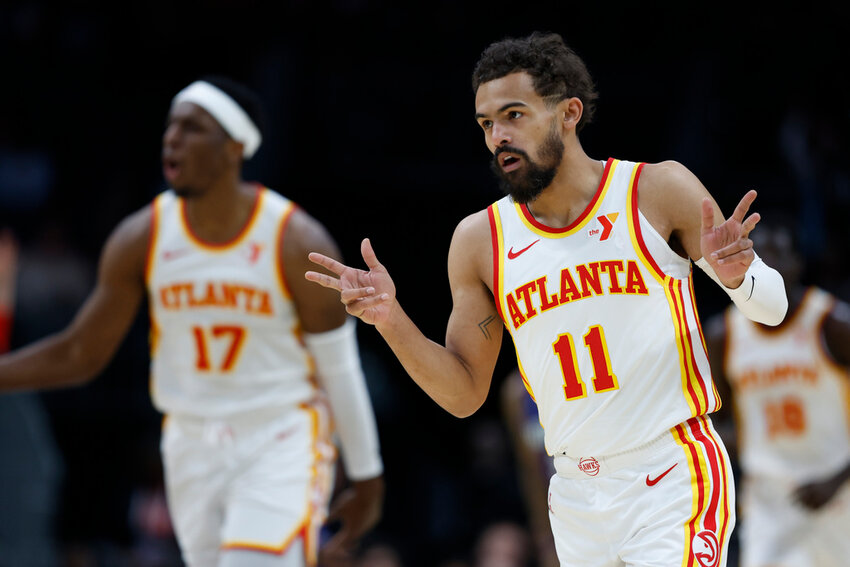 Atlanta Hawks guard Trae Young (11) gestures after making a three-point basket against the Charlotte Hornets during the first half in Charlotte, N.C., Tuesday, March 18, 2025. (AP Photo/Nell Redmond)